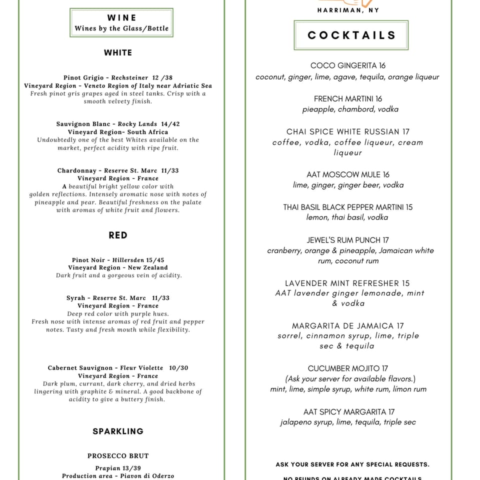 A white menu with green borders, listing various wines by the glass/bottle and cocktails.